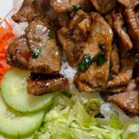 Com Beef · Steamed rice with lettuce, cilantro, cucumber, pickled carrots and daikon with a side of fis...