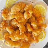 Lemon Chicken · Deep fried breaded chicken in lemon sauce served on top of lemon slices.