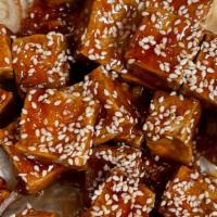 Sesame Tofu · Deep fried breaded tofu in sweet sauce topped with toasted sesame seeds.