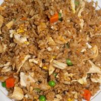 Chicken Fried Rice · Stir-fried rice with eggs peas and carrots.