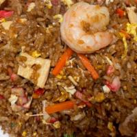 Combination Fried Rice · Stir-fried rice with eggs, peas, carrots, shrimp, pork, and chicken.