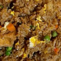 Tofu Fried Rice · Stir-fried rice with eggs peas and carrots.