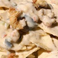 Cajun Nachos · Cheesy queso goodness scattered with jalapeños and jazzed up with Cajun flavors smothering y...