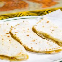 Cheese Quesadilla A La Carte · Melted cheese inside a folded grilled flour or corn tortilla with cheese only.