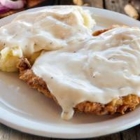 The Duke’S Chicken Fried Steak · A hand-cut sirloin battered, lightly fried, and covered with your choice of white or brown g...
