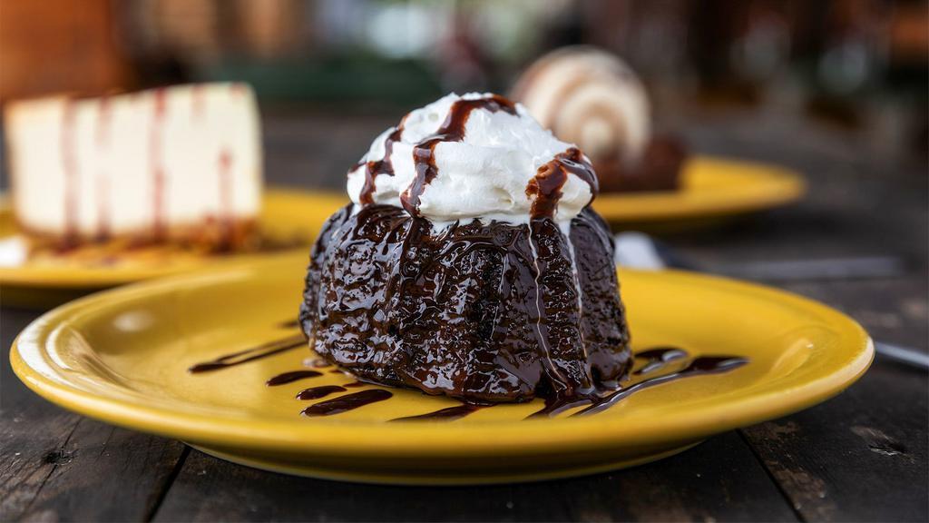 Chocolate Molten Cake · Warm chocolate cake drenched with dark chocolate. Topped with vanilla ice cream.
