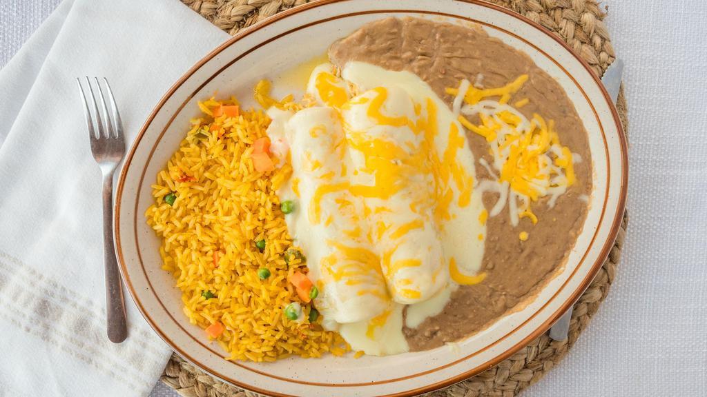 #6 (2) Chicken Enchiladas · Topped with cheese and served with sour cream or ranchera sauce, rice and beans.