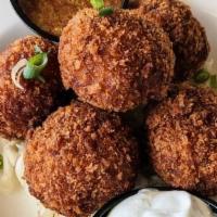 Sausage Balls · Bratwurst, Cleveland Kraut, Cream Cheese, & Spices deep-fried into balls!  Served on a bed o...