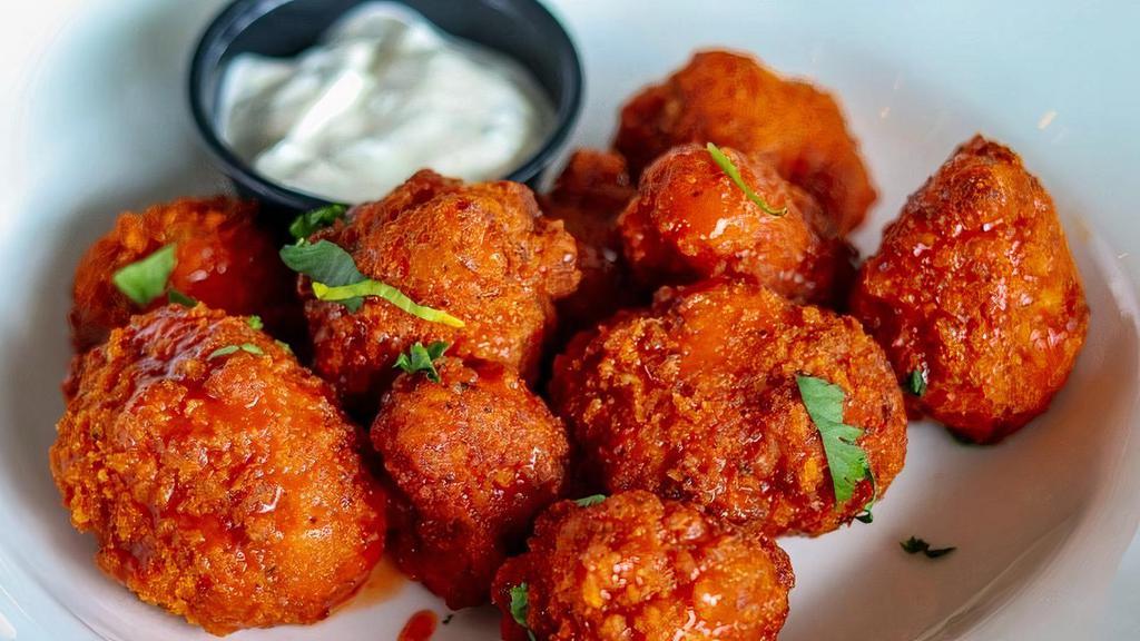 Buffalo Cauliflower Bites · Hand-breaded crispy cauliflower bites- a perfect vegetarian option that easily satisfies our frequent carnivore customers. Tossed in Buffalo Sauce & served with a side of House Ranch.