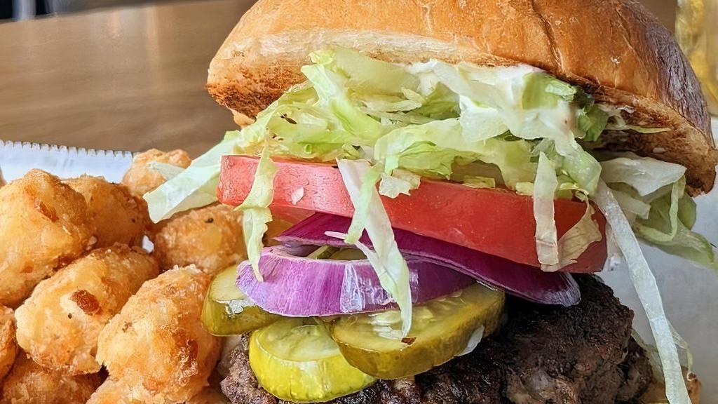 Juicy Luzie Burger · Local Beef Burger stuffed with Butterkase Cheese!   Served on a Brioche Bun with Kraut Mayo, House Pickles, Red Onion, & Tomato. Served with Fries or Tots.