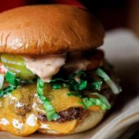 Cali-Style Double Cheeseburger**  Gfo · tillamook cheddar, shredded lettuce, toms, grilled onion, pickles, pink sauce, potato bun. *...