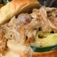 Alabama Chicken · Pulled chicken piled high topped with Alabama white sauce & house-made pickles on toasted po...