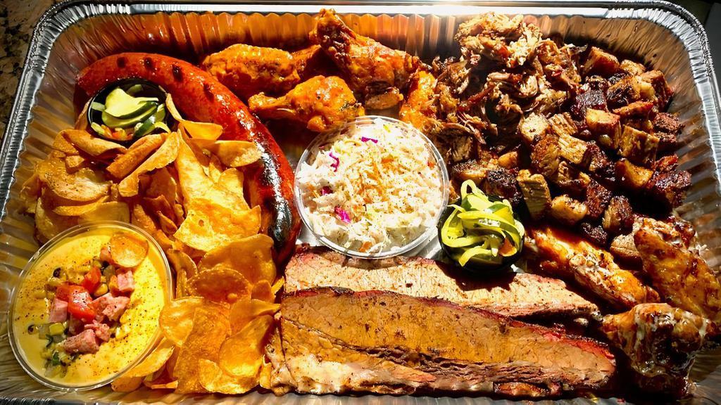 Family Bbq Meat Feast · NO SUBSTITUTIONS: **1 Lb each: Brisket OR Burnt Ends, Pulled Pork & Smoked Kielbasa **12 Wings, 2 sauce options ** 2 Buttered Cornbread (split in half) **Slaw **Queso Dip **House Chips **House Pickles