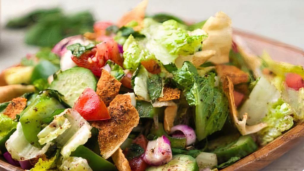 Fattoush · Romaine lettuce, tomato, onion, crisp cucumber, tossed with freshly toasted pita chips and sumac, house dressing on the side.