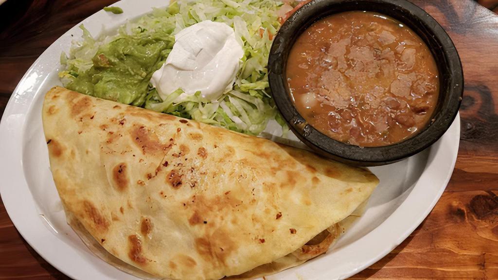 Quesadilla Grande · A Large Flour Tortilla filled with Grilled Chicken and Cheese, served with Lettuce, Pico de Gallo, Guacamole, Sour Cream & Charro Beans.