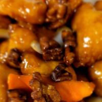 #32. Honey Walnut Chicken  · Chunks of battered chicken covered in a honey sauce and topped with walnuts.