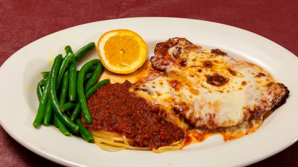 Chicken Parmigiana · Carved boneless breasts pounded flat, breaded with Italian bread crumbs, then baked in a light tomato sauce topped with melted mozzarella. Served with side pasta.