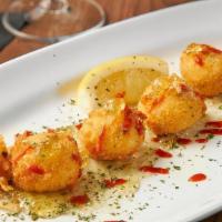 Crab Beignets · Crab and Boursen Cheese rolled in a light tempura batter, drizzled with white rémoulade and ...
