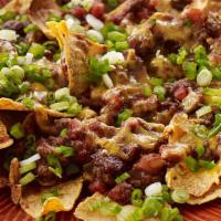 Ground Beef Nacho · Served with Fresh Beef, Round Tortilla Chips, Sour Cream, Jalapeno Pepper, Onion, Tomato & N...