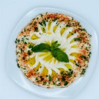 Muthawama · Thick garlic and cream dip serevd with, parsley, sumac, olive oil.