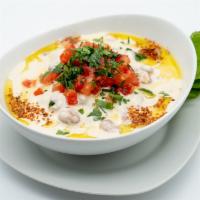 Syrian Ful Mudammas · Fava beans, fresh cut tomatoes, pepper, garlic, parsley, tahini sauce, olive oil served with...