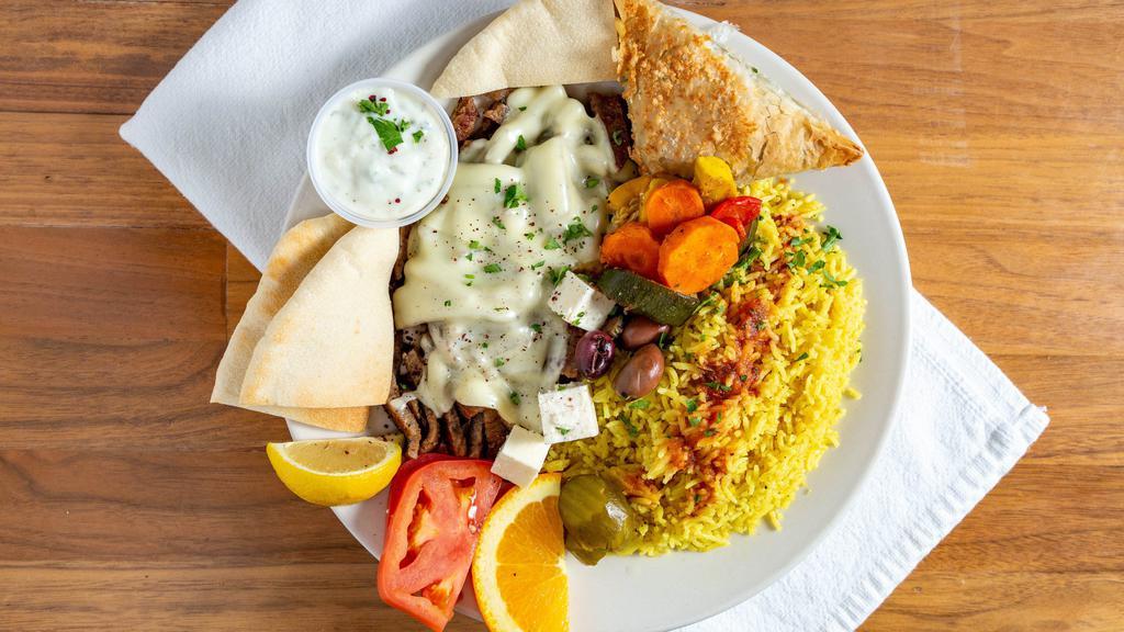 Gyros Platter · Fan Favorite. Grilled slices of gyros meat topped with swiss cheese. Served with tomatoes, onions, kalamata olives, feta cheese, spinach pastry (spanakopita), gyros sauce, and pita bread.