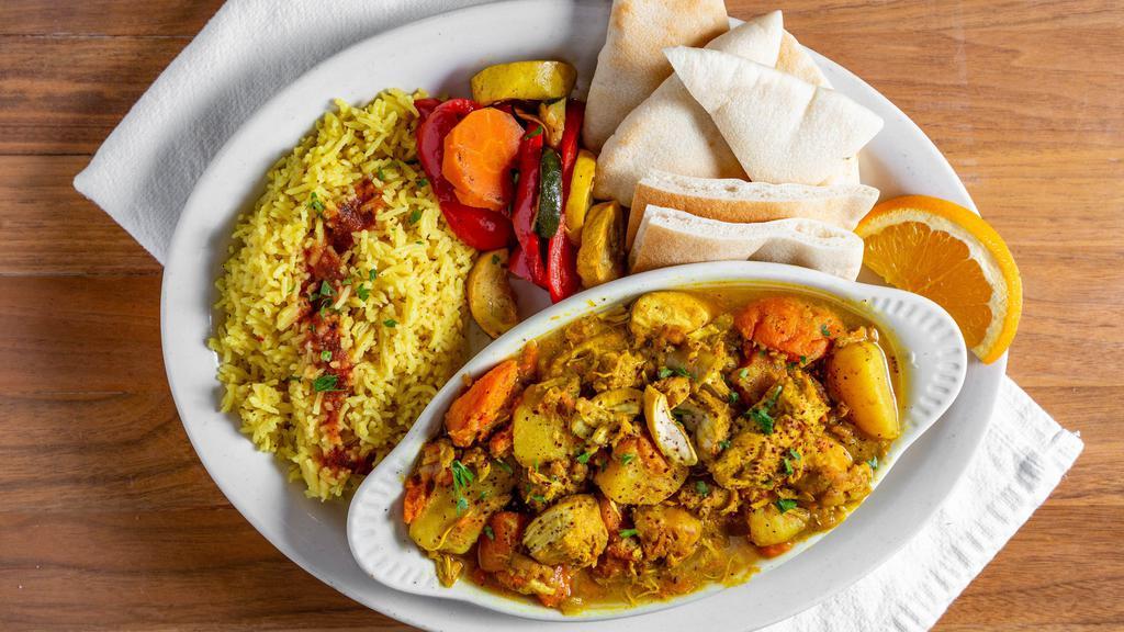 Curry Chicken · Marinated chicken breast grilled then baked with potatoes and carrots in a delicious mild curry sauce. Served with pita bread.