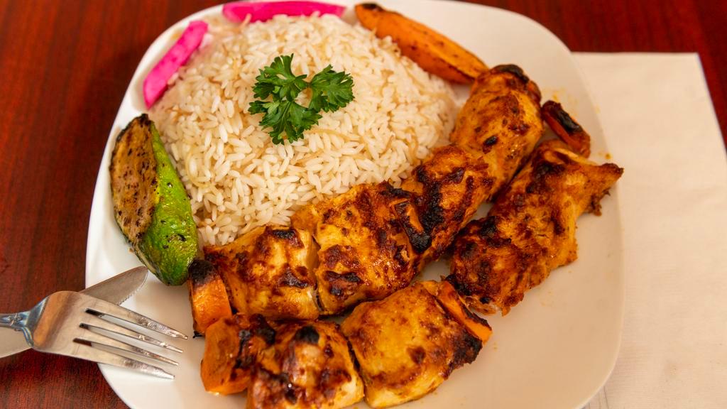 Shish Tawook · Most popular. Char broiled white meat chicken marinated in garlic sauce. Served with choice of side and soup or house salad.