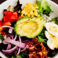 Grilled Chicken Cobb · Mixed greens, corn, avocado, red onion, bacon, tomatoes, egg, bleu cheese crumbles, served w...