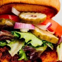 Nashville Hot Chicken · Buttermilk fried chicken tossed in Nashville dry rub, ranch, pickles, lettuce, tomato, red o...