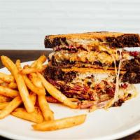Reuben · Parmigiano crusted marble rye, corned beef, swiss cheese, sauerkraut, and housemade 1,000 is...