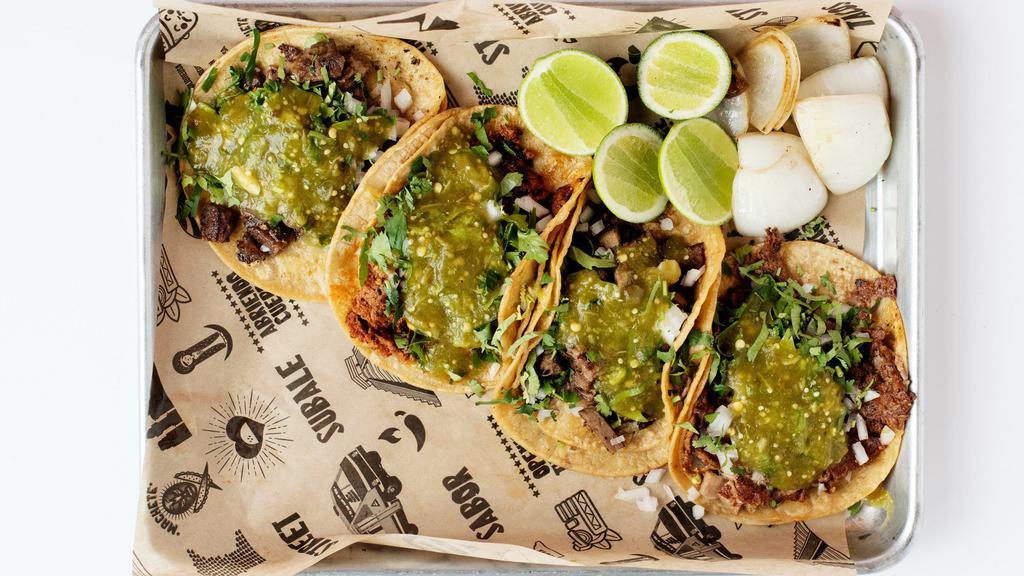 Tacos Street · Choice of meat, topped with onions & cilantro on a corn tortilla with lime.