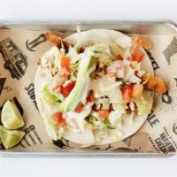 Tacos Fish · Topped with avocado, queso dip, lettuce & tomato on a flour tortilla.