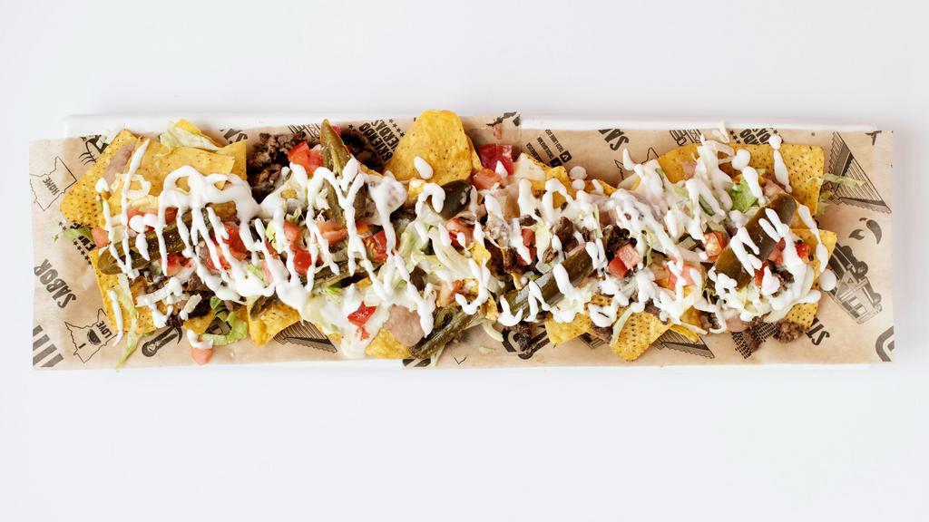 Nachos · Choice of meat, refried beans, queso dip, lettuce, tomato, jalapeños & sour cream.