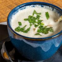 Tom Kha · Spicy. House-made creamy coconut curry broth steeped with lemongrass, shiitake mushrooms, gr...