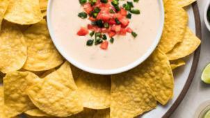 Queso Dip And Chips · cheese with green chilies and garlic.