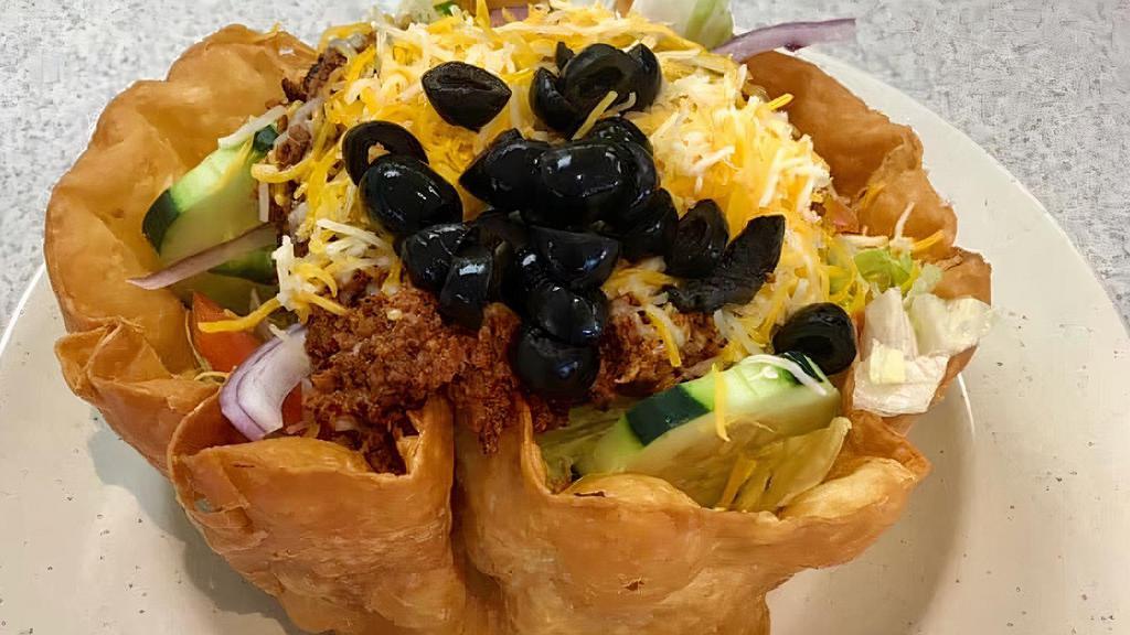 Taco Salad · Choice of beef or chicken with iceberg lettuce, cucumbers, black olives, tomatoes, onion & Cheddar in a taco shell. Includes salsa & sour cream.