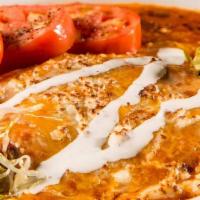 Stacked Chicken Enchilada · Roasted chicken and shredded cheese layered between corn tortillas. Topped with enchilada sa...