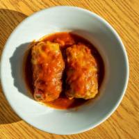 Cabbage Rolls · Cabbage leaves stuffed with basmati rice, beef + simmered in tomato sauce.