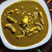 Green Egg Curry · Pieces of boiled eggs cooked in a mint based gravy.