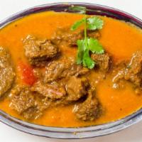 Lamb Rogan Josh · Cooked with tomato sauce and herbs.