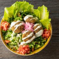 Falafel Salad · Mouthwatering falafel salad with tomatoes, green peppers, cucumbers, lettuce, parsley and sp...