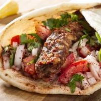 Shish Kebab Wrap · Three pieces of beef kebab wrapped skillfully with tomatoes, onions, and sauce.
