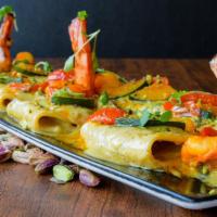 Paccheri In Salsa Di Pistacchio · Paccheri, tiger prawns, zucchini and grape tomatoes in Sicilian-Bronte pistachio sauce
