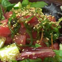 Poke Don · Ahi tuna, spring mix, cucumber, sesame seeds, wasabi, spicy or non-spicy sauce over the rice.