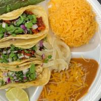 Taco Plate · Three tacos with your choice of meat, cilantro, onion and lime. Served with rice and beans.
