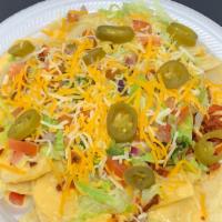 Nacho Supreme · Your choice of meat with nacho cheese, jalapeños, beans, onions, cilantro, tomato, lettuce, ...