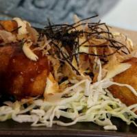 Takoyaki · Octopus dumpling with aonori, okonomi sauce, mayo, and bonito flakes.