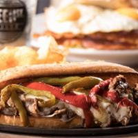 Philly Cheesesteak · Juicy, chopped grilled steak with grilled onions and peppers and melted provolone cheese on ...