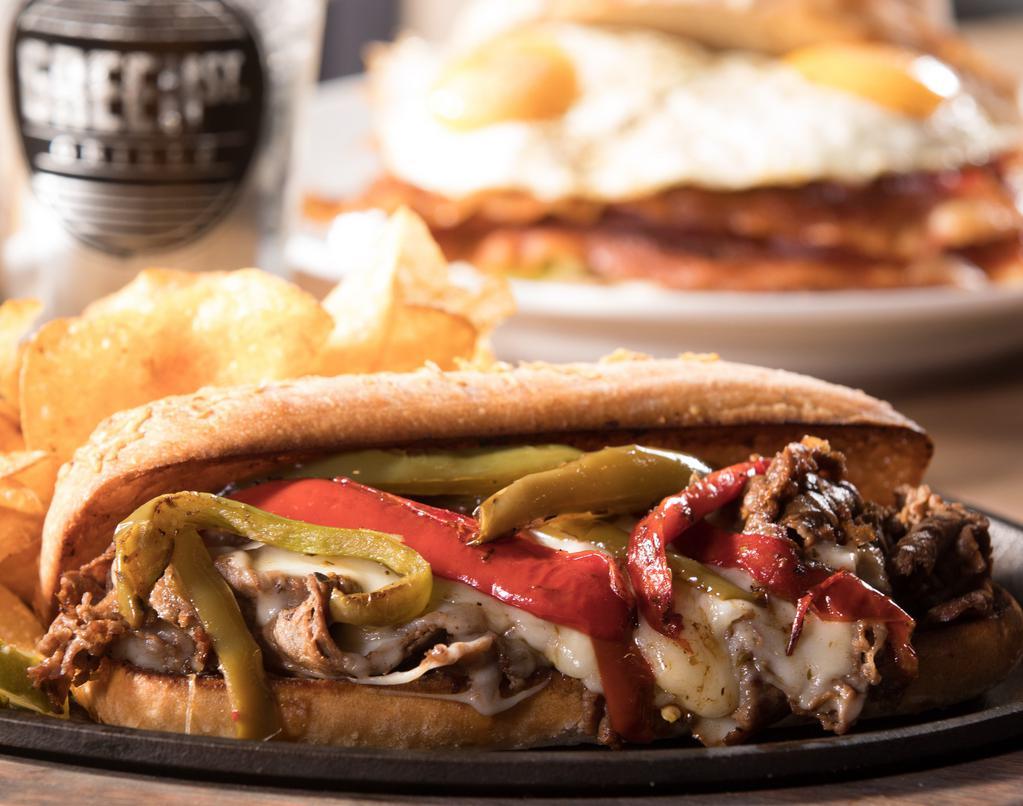 Philly Cheesesteak · Juicy, chopped grilled steak with grilled onions and peppers and melted provolone cheese on a soft hoagie roll.